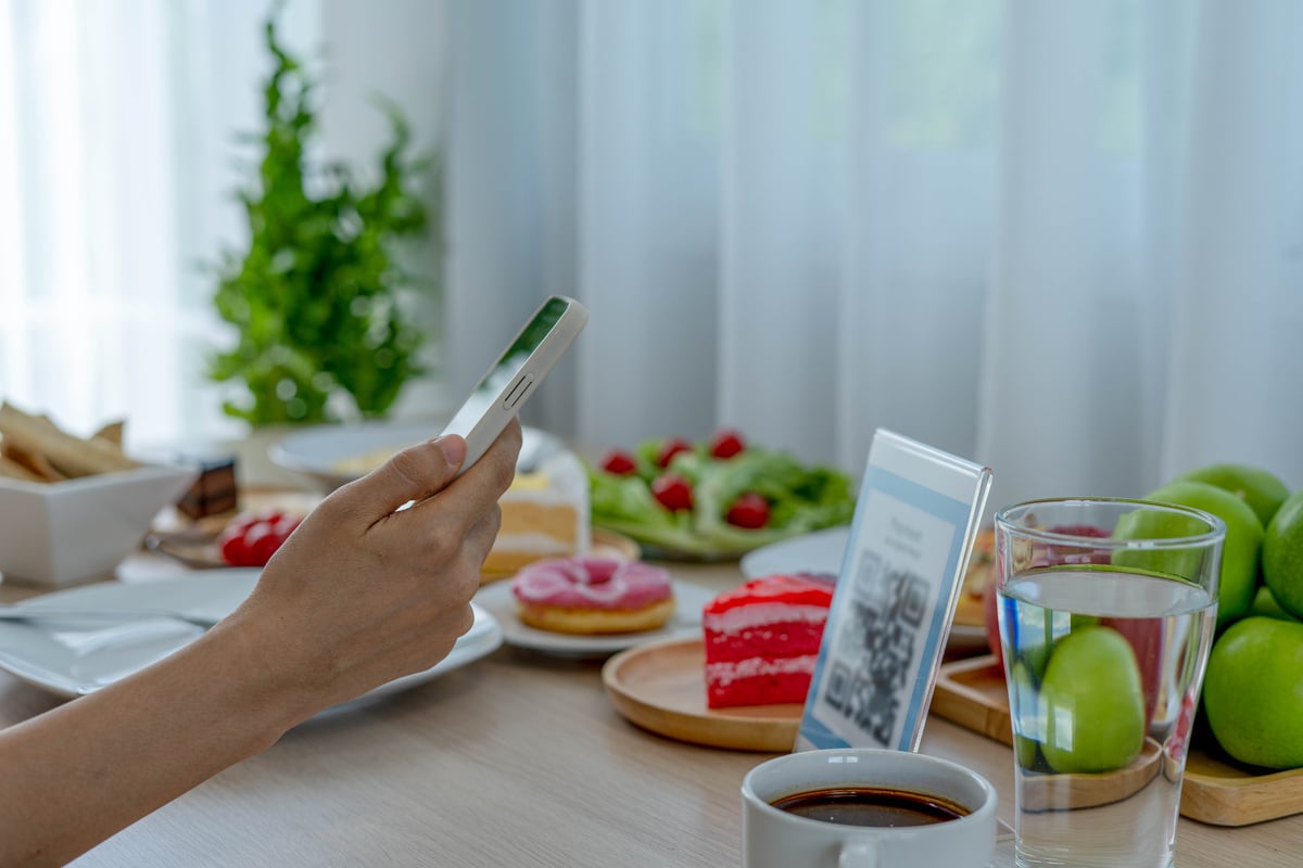 Woman Uses Phone to Qr Code Scanning for Food Payment